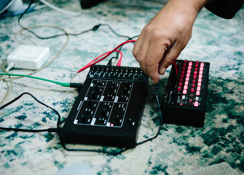 hand adjusting a sequencer