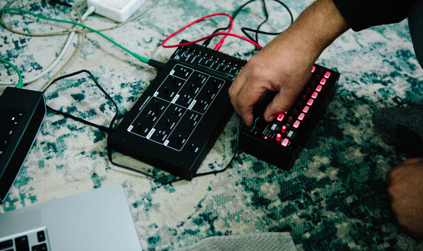 hand adjusting a sequencer