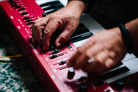 Hands playing a monophonic synthesizer