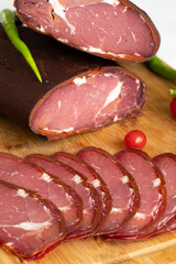 Turkish pastrami on a white background. Whole and sliced pastrami. pastrami is made from the ribeye and beef fillet parts of the cow. Local name pastırma