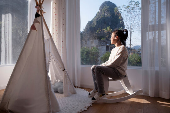 Asian little girl in front of tent in bedroom at home. Shining the sunset