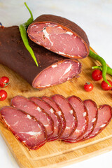 Turkish pastrami on a white background. Whole and sliced pastrami. pastrami is made from the ribeye and beef fillet parts of the cow. Local name pastırma