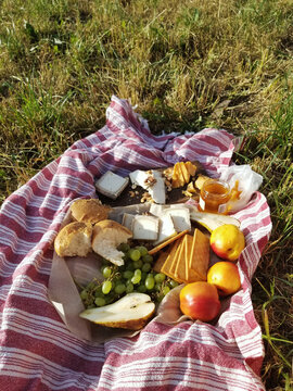 
Romantic picnic with wine, cheese, baguette, jamon and fruits