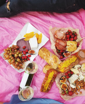
Romantic picnic with wine, cheese, baguette, jamon and fruits