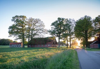 Fototapeta na wymiar old barns and farm at sunset in rural area of twente near oldenzaal in holland