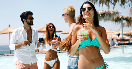 Group of happy friends having fun on beach, summer holiday party