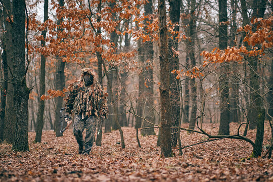 Bow hunter in ghillie suit