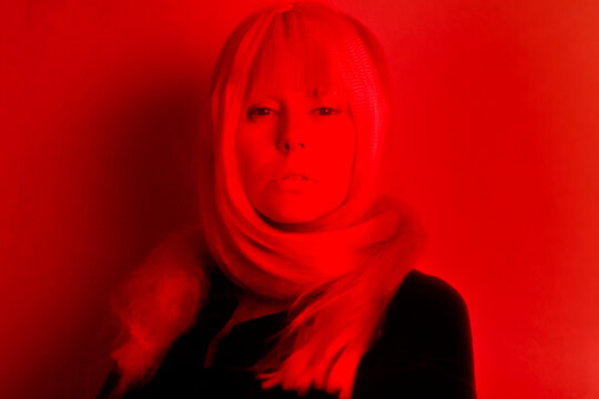 Futurist portrait of a beautiful woman with red neon light 