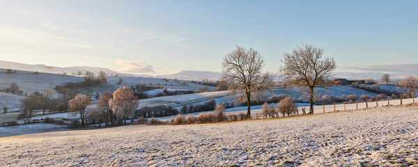Cumbrian fells covered in snow at sunrise. Kirkby Stephen, Cumbria, UK.
