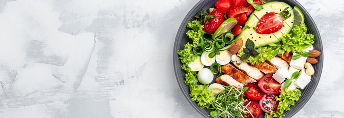 Ketogenic low carbs diet, keto foods grilled chicken and avocado, feta cheese, quail eggs,...