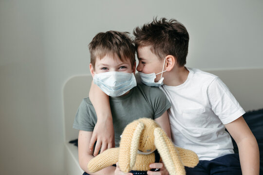 Young brothers in protective medical masks.