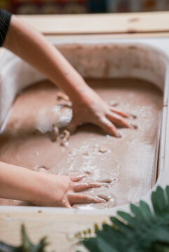 young girl gets very messy and muddy with oobleck mud in preschool 