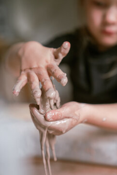 young girl gets very messy and muddy with oobleck mud in preschool 