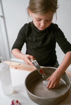 young girl's dinosaur excavation science in preschool 11