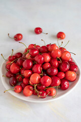 Ripe cherries on a white background. cherry on plate