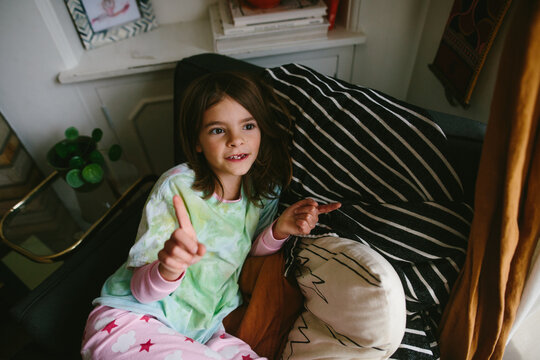 overhead view of little girl with toothless smile