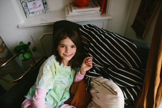 overhead view of little girl with toothless smile