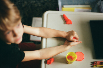 Young boy attends art class during distance learning kindergarten