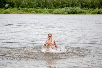 happy boy splashing in the river