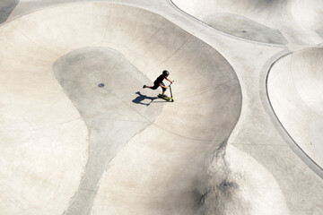 Boy riding scooter on ramp 
