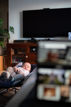 Baby resting in cot in living room