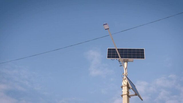 Modern lamp in frozen day. A view of a moderm lamp in the blue light sky.