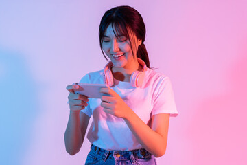 Young Asian girl playing game on phone with excitement