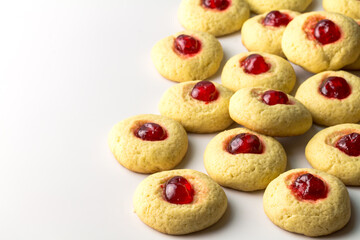 Cherry cookies on white - delicious cherry topped cookie background with space for text
