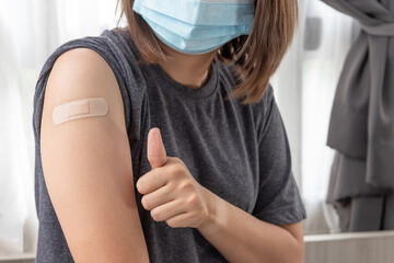 Asian woman thump up and Confident after being vaccine covid,Confirm vaccination is safe