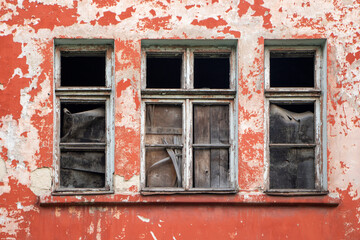 Fototapeta na wymiar Broken old window on the red wall