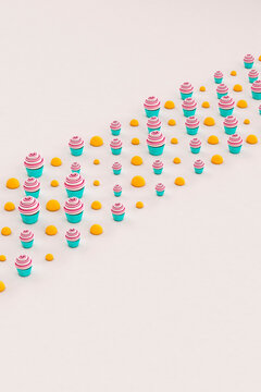 Cupcakes and orange balls on grey background