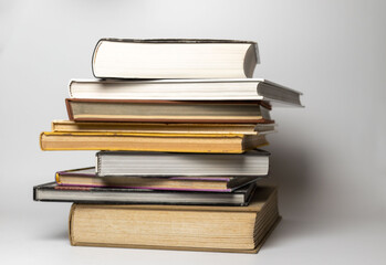 Pile of books in hard covers on a white background