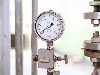 Pressure gauge of measuring instrument close up in industry zone at power plant with closed up