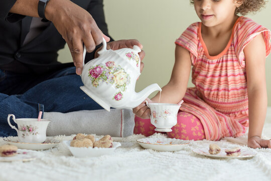 Man pours from floral china teapot