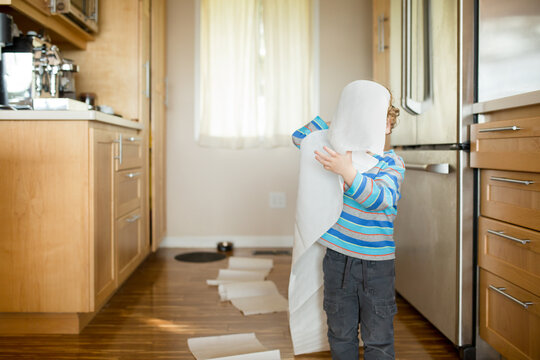 Toddler makes mess with paper towels