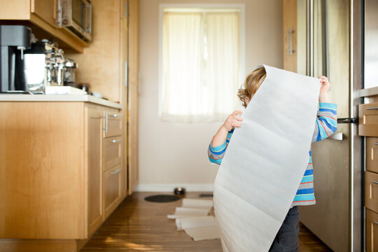 Child hides behind paper towels