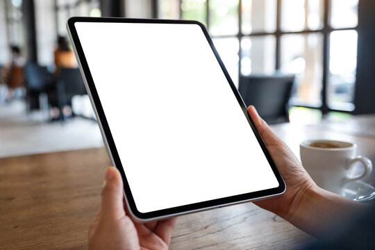 Mockup image of a woman holding digital tablet with blank white desktop screen