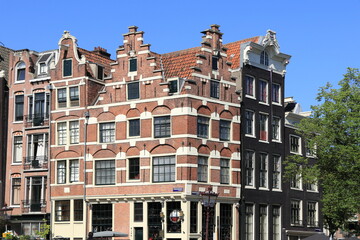 Fototapeta premium Amsterdam Historic Canal House Facades with Blue Sky