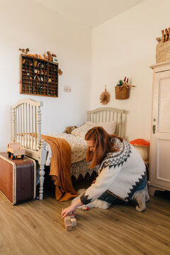 Woman tidies up the nursery