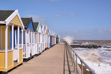 Row of brightly coloured beach huts on the seafront at Southwold.