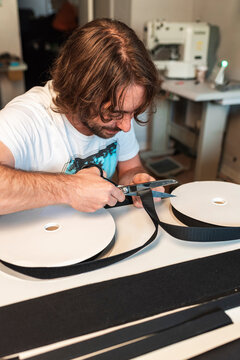 Textile designer using scissors to cut fabric