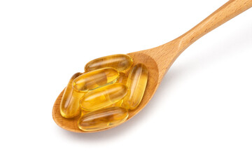 Fish oil. Wooden spoon with Omega 3 capsules isolated on white background. Close up.