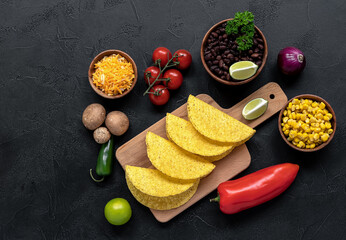 Vegetarian tacos with mushrooms, beans, peppers, and sauce.