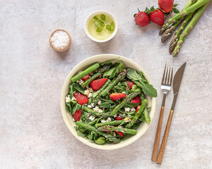 Strawberry, spinach, green asparagus, arugula, and feta cheese salad.