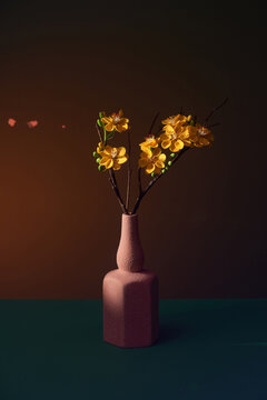Ochna integerrima (apricot blossom) in a vase over color background with reflection