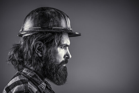 Building, Industry, Technology - Builder Concept. Bearded Man Worker With Beard In Building Helmet Or Hard Hat. Black And White