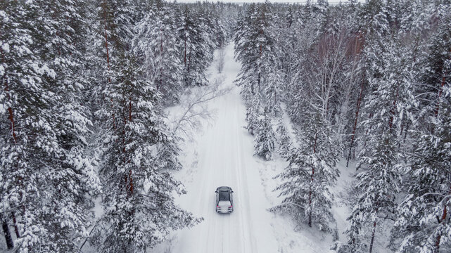 Overhead view Of a brand new black Car on a winter road