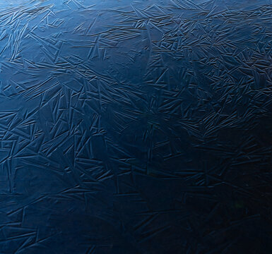 Blue ice shapes on a frozen pond