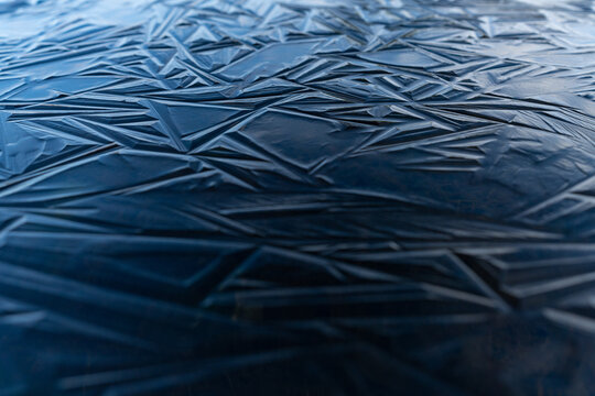Blue ice shapes on a frozen pond