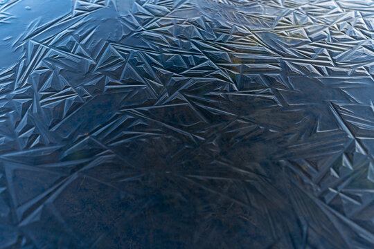 Blue ice shapes on a frozen pond